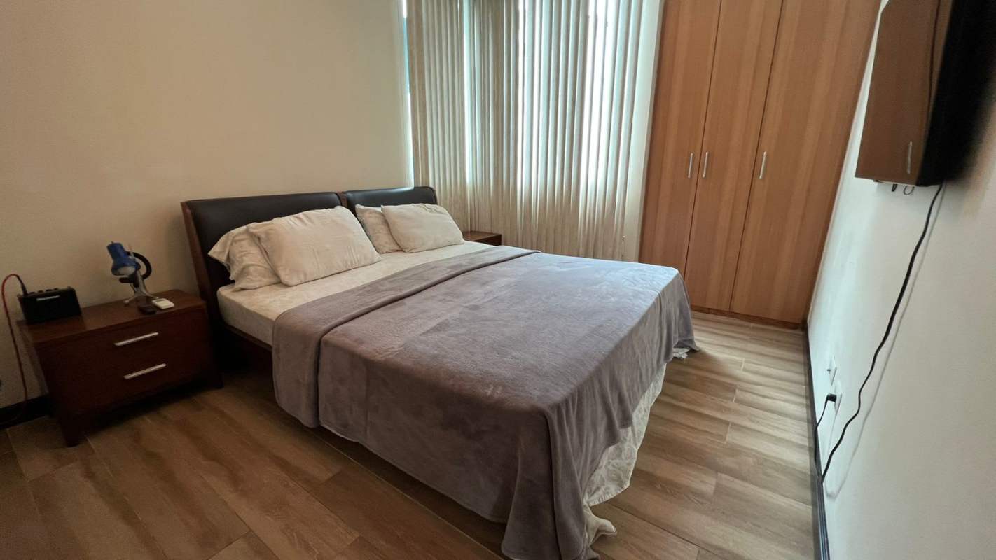 Modern covered outdoor swimming pool with city skyline and partial ocean view in PH Pacific Sun Panama