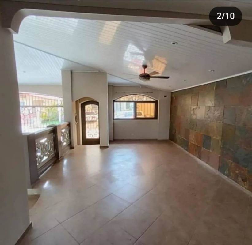Spacious covered rear terrace with decorative tiles in backyard Panama City