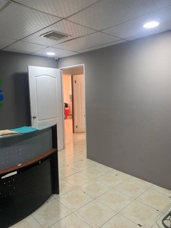 Modern reception space with tiled floor and curved reception desk at PH Obarrio Tower commercial offices in Panama City