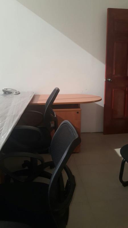 Contemporary office with wood desk, mesh chairs, tiled flooring inside PH Obarrio Tower Panama Financial Center