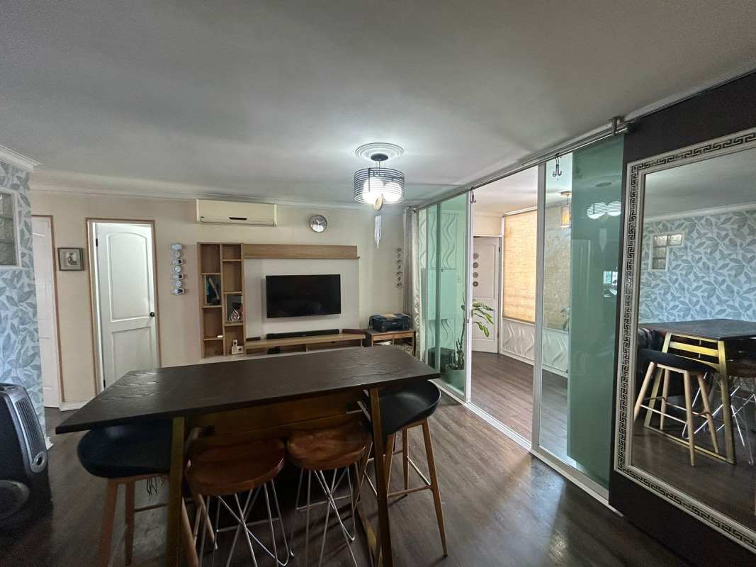 Bedroom with built-in closet and window views in Panama apartment Edison Park
