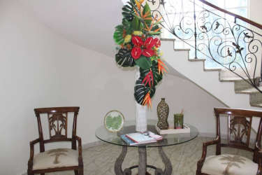Dining area with wood furniture, garden view, traditional decor luxury home Coronado Panama