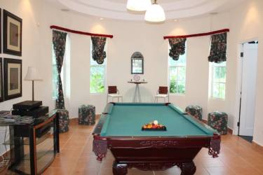 Indoor game room with pool table, large windows, traditional design luxury home in Coronado Panama