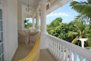Large balcony with hammocks, tropical garden views, colonial style luxury villa Panama