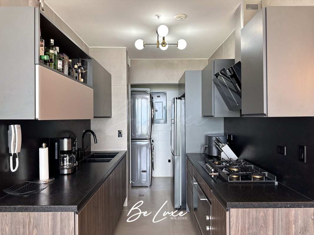 Fully fitted kitchen with granite counters and laundry at PH Victory Sport Panama City