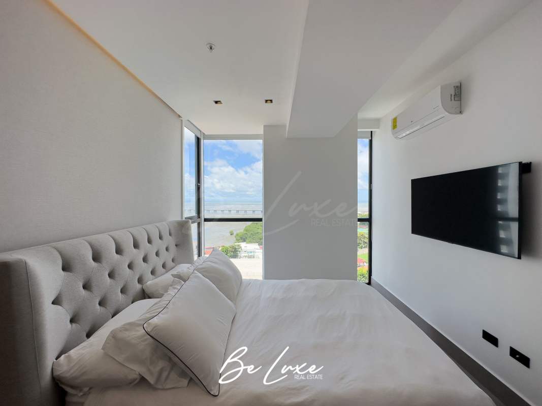Modern bedroom flooded with light and city/ocean views in PH Victory Sport Panama