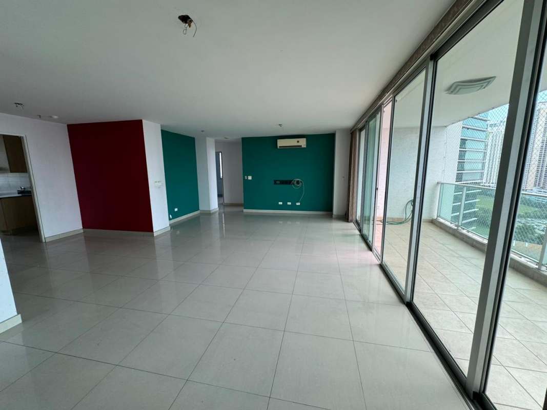 Modern living room with floor-to-ceiling windows, open plan design, balcony access PH Sevilla Costa del Este Panama