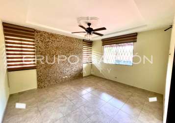 Bedroom with tile floors, ceiling fan, window with garden view, Howard house Panama Pacifico