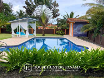 Modern bathroom with glass shower and tiled walls inside gated community home in Portobelo Panama