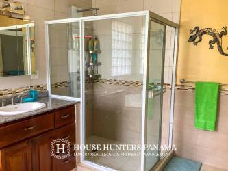 Bathroom with modern tiled design, walk-in shower, vanity in Caribbean style home Portobelo Panama