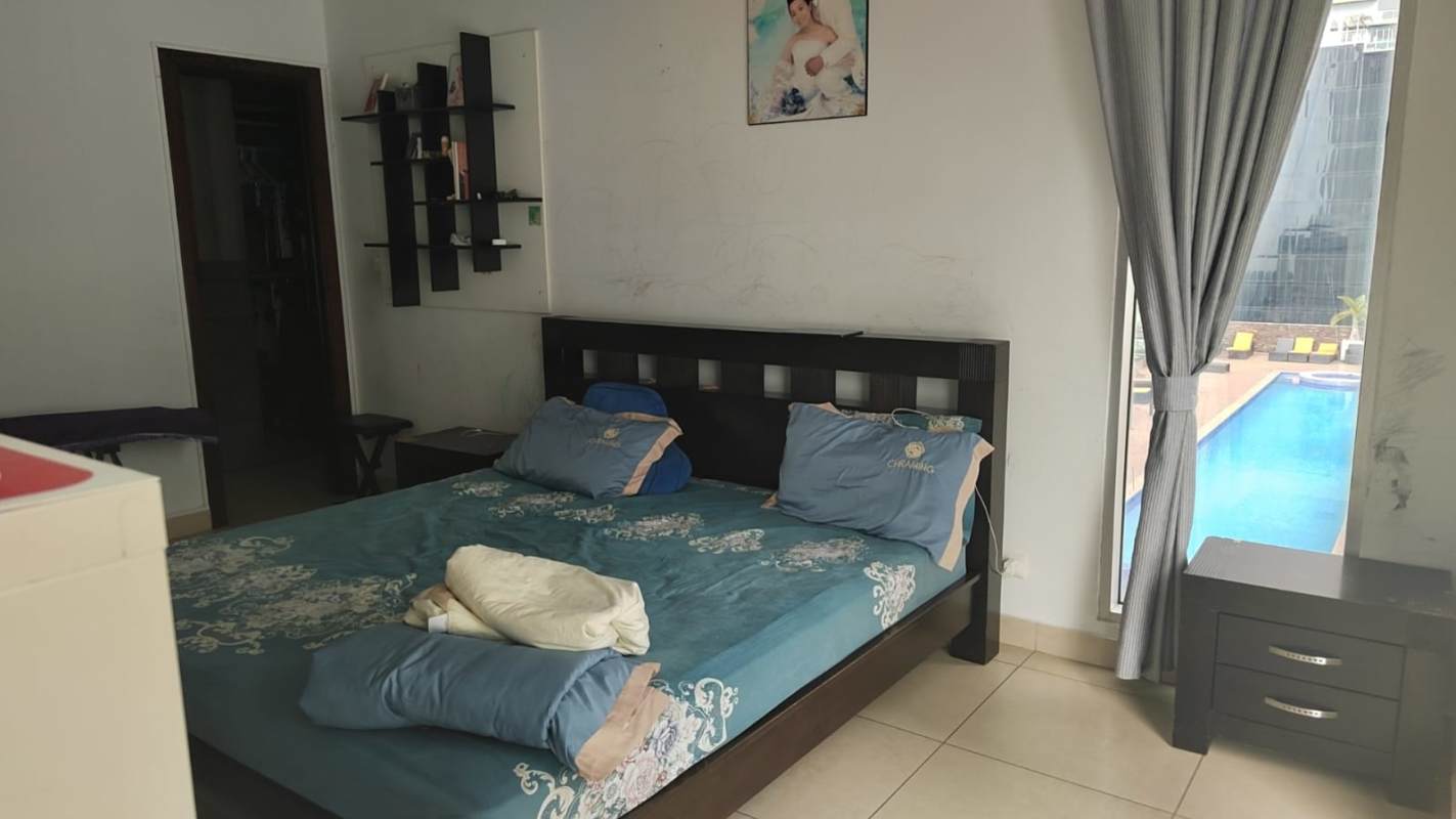 Modern bedroom with large window, ocean views and tile floors at PH Rivage Marbella Panama City