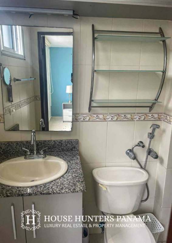 Contemporary bathroom with granite counters and glass shelves in PH Torres del Mar del Sur San Francisco Panama