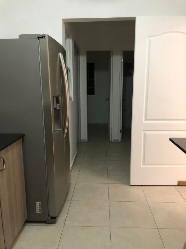 Kitchen view with stainless steel refrigerator and hallway Villas del Golf Brisas del Golf