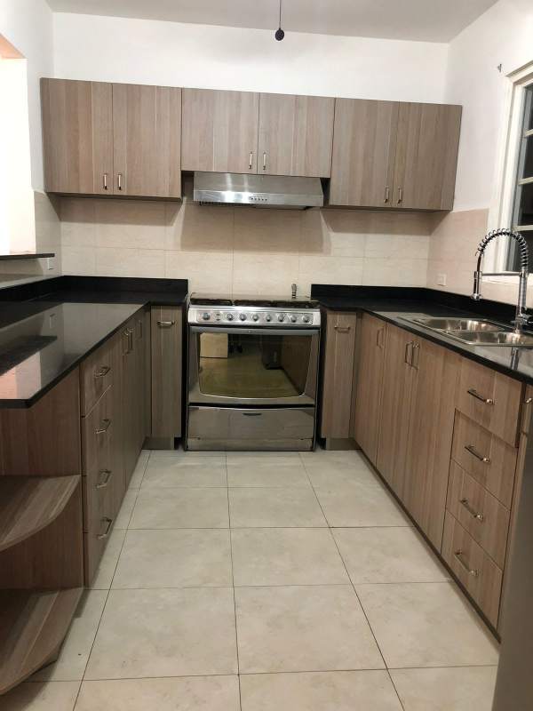 Kitchen with black granite countertop and wooden cabinets Villas del Golf Brisas del Golf Panama