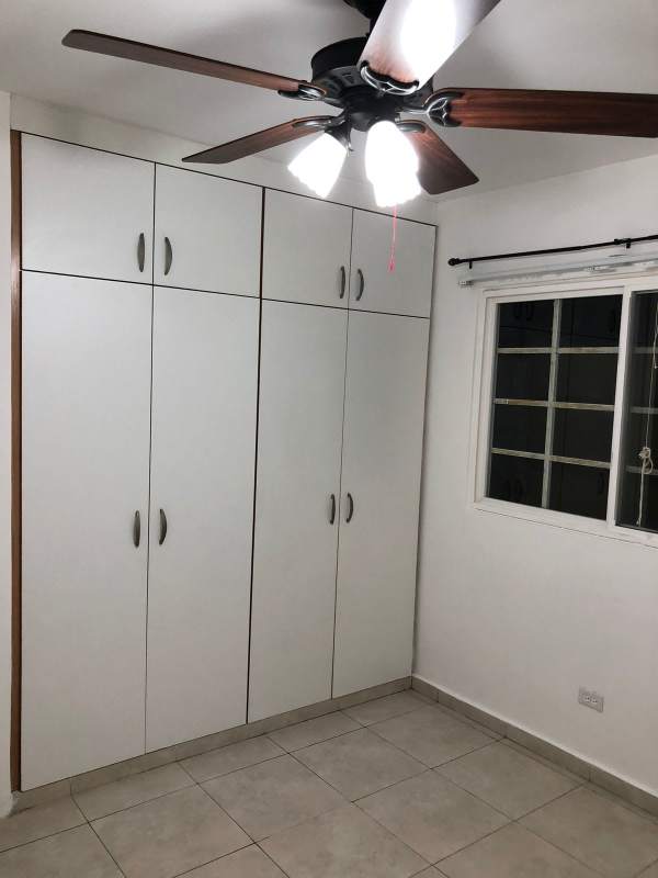 Bedroom with closets and ceiling fan in Brisas del Golf Panama City house