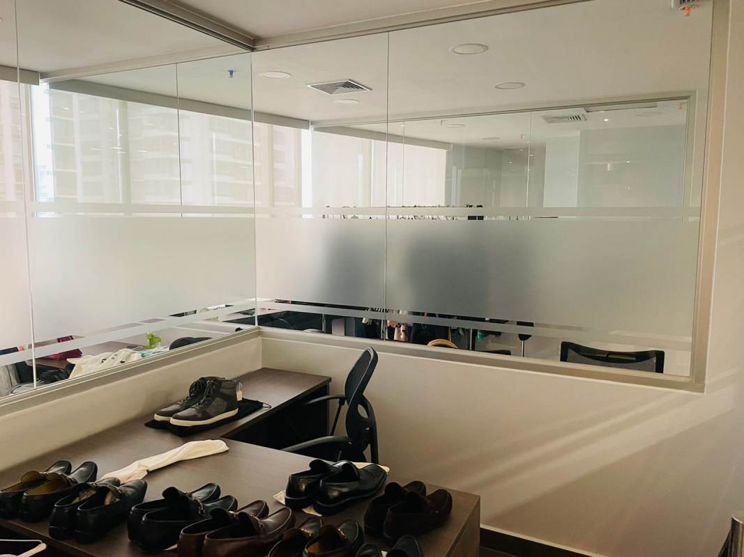 Hallway with glass walls leading to furnished offices at Financial Park in Costa del Este Panama