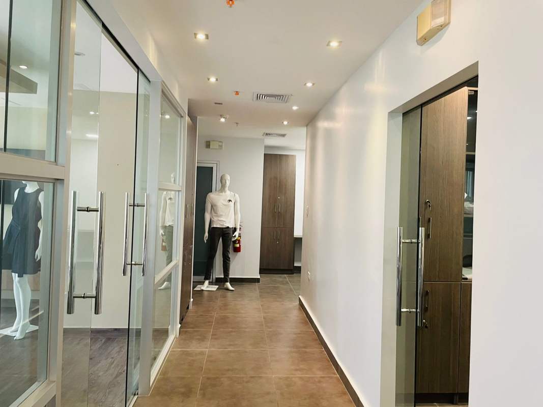 Modern restroom with beige tiles, pedestal sink inside Costa del Este corporate office Panama