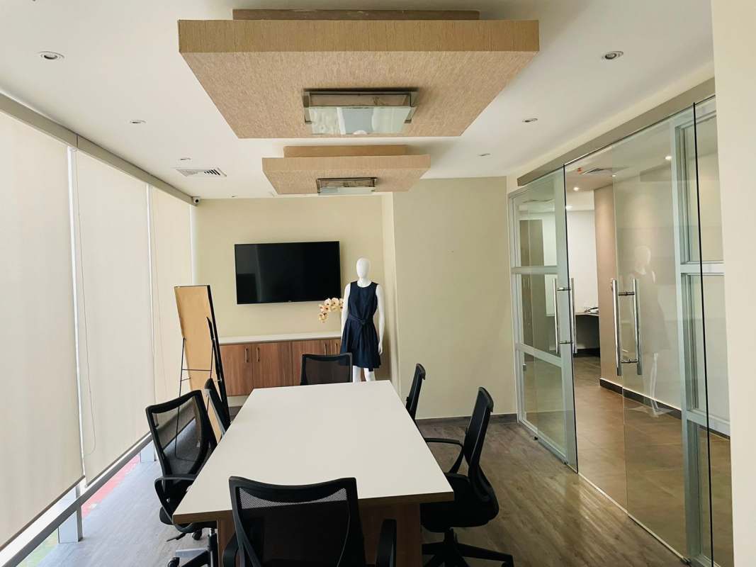 Glass-walled conference room with chairs and screen in Costa del Este corporate building Panama
