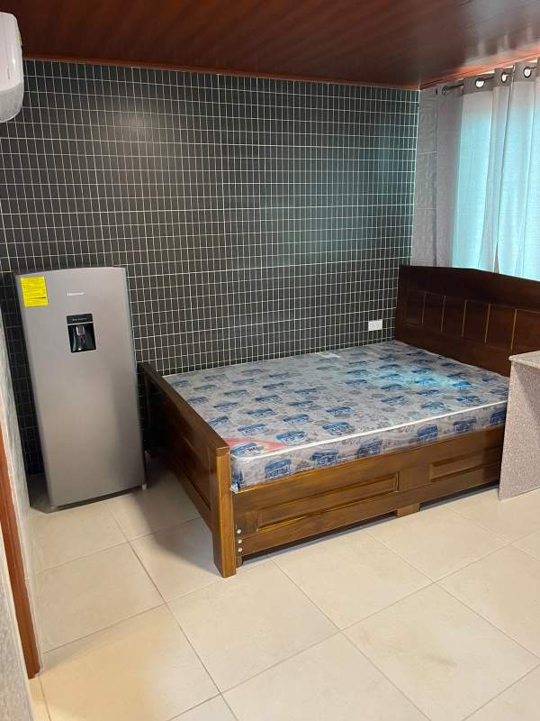 Dining space with mounted TV and textured tiles studio in El Dorado Panama