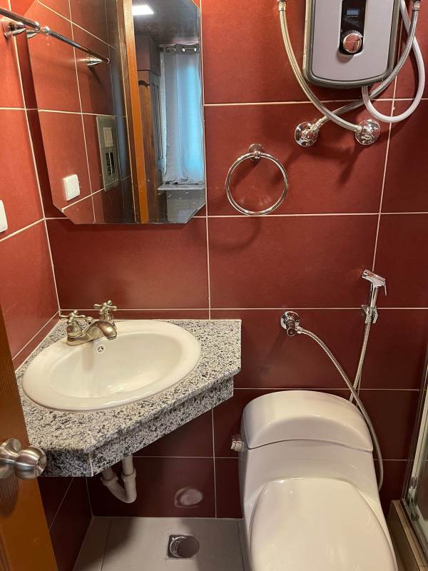Small bathroom with granite countertop sink, wall mirror, red tiles PH El Dorado Midtown Panama