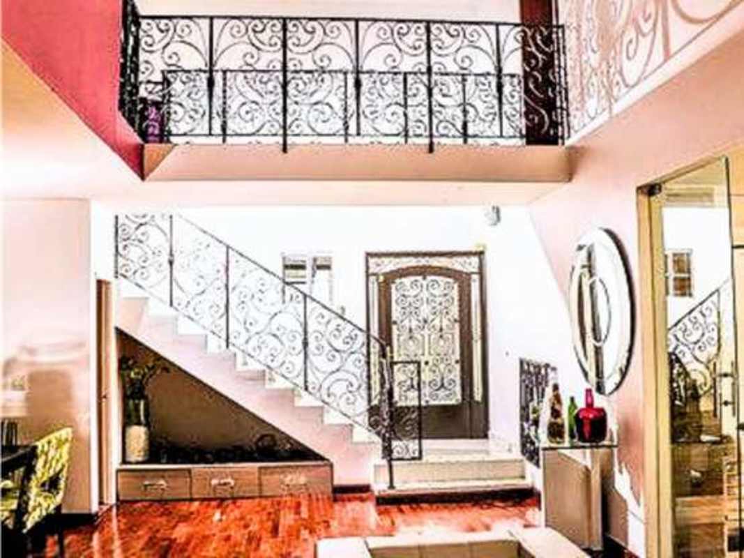 Modern kitchen granite counters open to dining area in spacious corner house Condado del Rey Panama