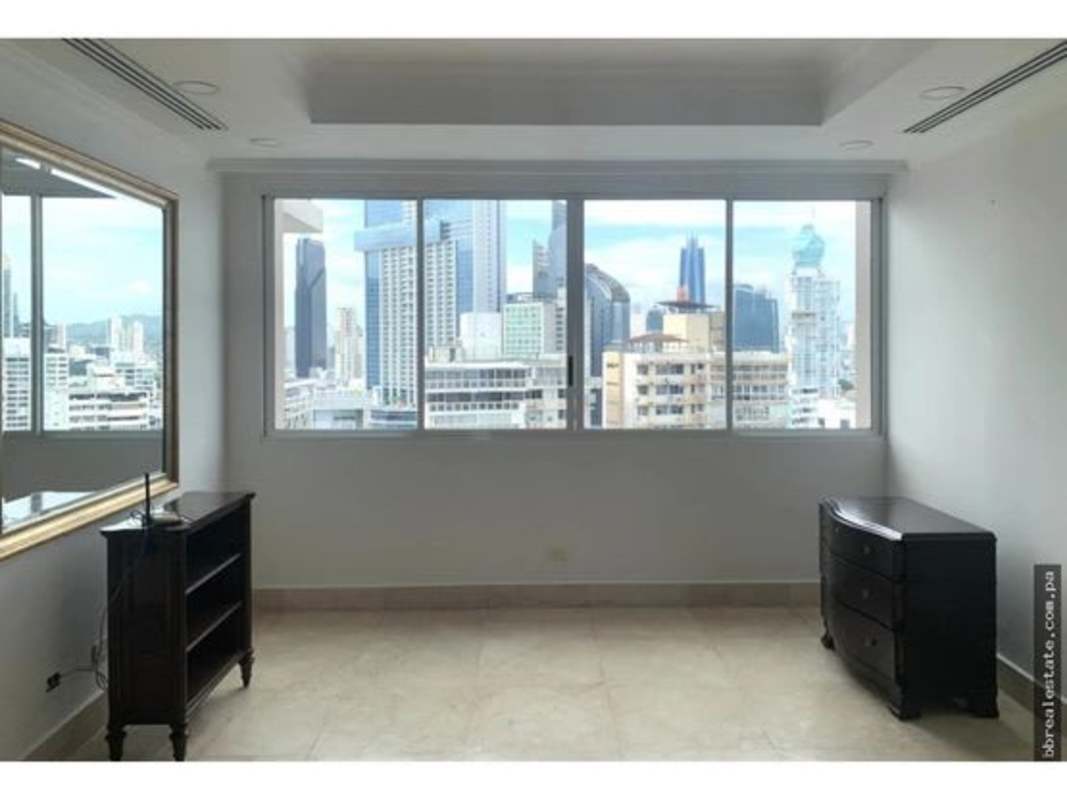 Bedroom with ocean and skyline views through large windows in PH City Tower Punta Paitilla