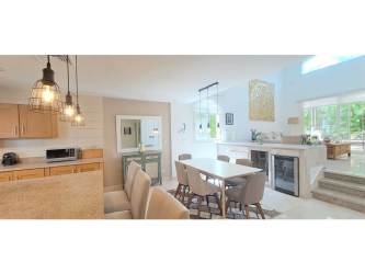 Open concept living room with high ceilings and large glass doors to terrace and pool in Tucan Country Club Panama