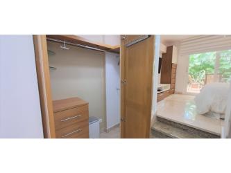 Covered outdoor terrace overlooking private pool and garden in Tucan Country Club luxury villa