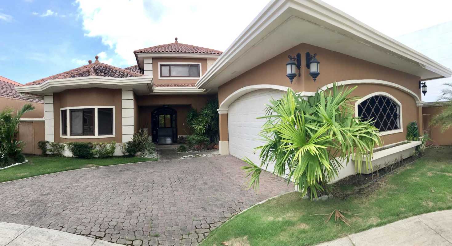 Modern open kitchen with granite countertops and wood cabinets in Sunset Coast Costa Sur