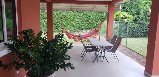 Lush garden backyard with terrace and outdoor sitting area in beach house Villas de la Colonia Panama