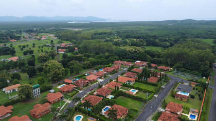 Aerial panoramic of Villas de la Colonia with tropical houses, red roofs and green landscape, Chame Panama