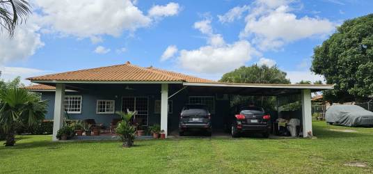 Screen-enclosed outdoor swimming pool with brick paver deck and tropical landscaping at Cabuya Panama estate