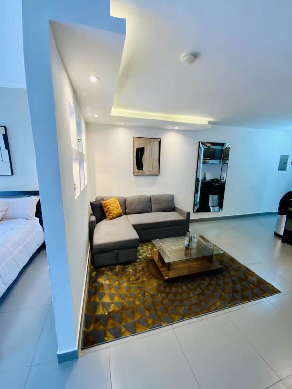 Open layout studio apartment with kitchen and living area, modern design, panoramic window in PH Colores de Bella Vista Panama City