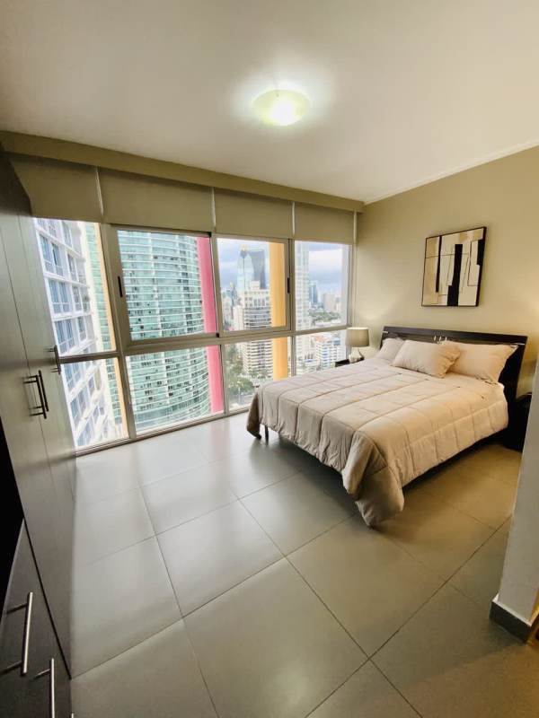 Sleeping area with large closet neutral decor panoramic window studio in PH Colores de Bella Vista