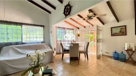Bright open-plan living dining space exposed beams ceramic floors Coronado