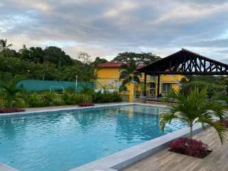 Large tropical swimming pool with sun deck at Rio Hato Panama aparthotel