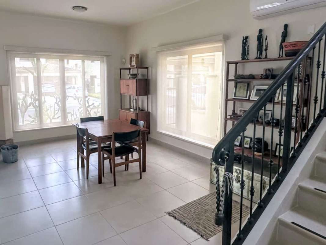 Modern bright dining area with staircase and large windows Embassy Club Clayton