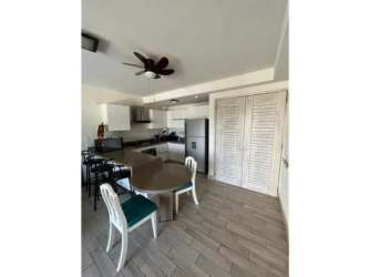 Equipped kitchen with white cabinets, gas stove, oven, stainless appliances in Playa Caracol