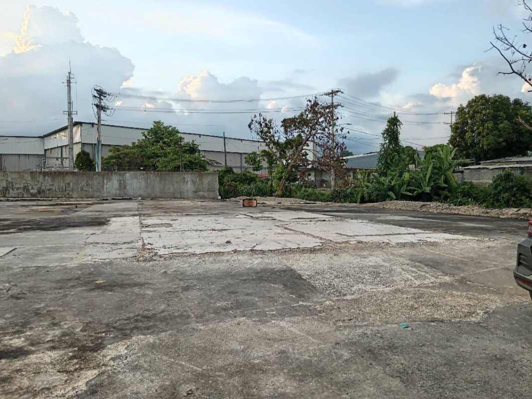Large open paved industrial lot with perimeter wall and warehouses at Río Abajo Panama