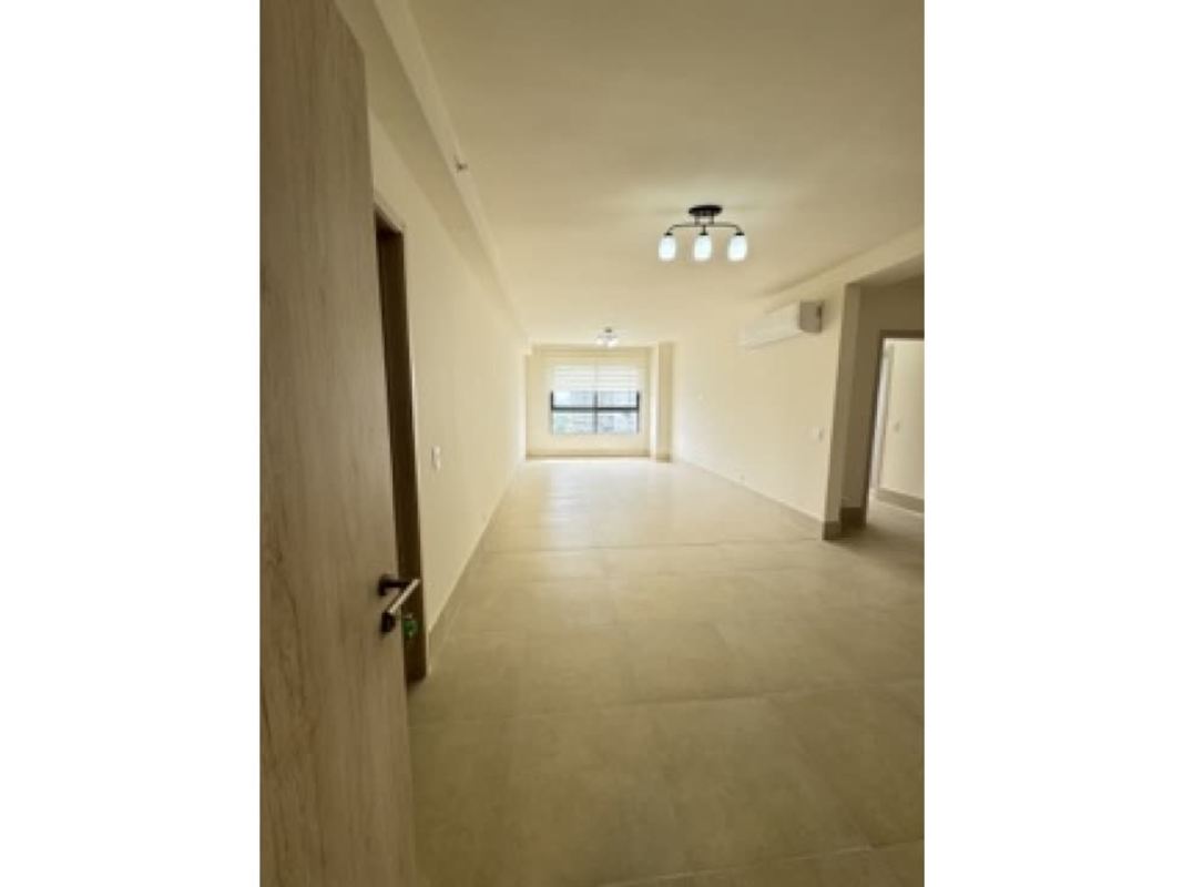 Bright hallway with modern finishes connects living to bedrooms at Ocean House Santa María