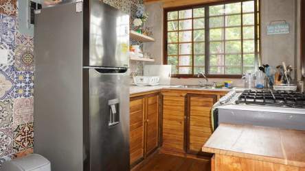 Rustic living space with natural wood interior at Altos del María cabin