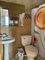 Bedroom with tile floors, ceiling fan, window garden view at Costa Esmeralda beach property