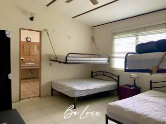 Minimalist bedroom with bunk beds and tile floor in Costa Esmeralda beach villa