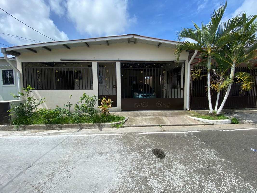 Simple living dining space with blue curtains and tiled floors house Los Álamos Pacora Panama
