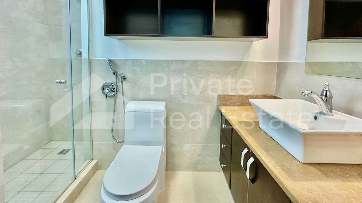 Modern bathroom with marble twin sinks and glass shower PH Titanium Costa del Este Panama