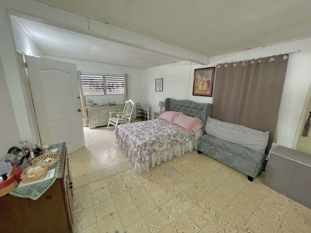 Bedroom with floral bedding, ceiling fan, closet space in Cerro Viento Panama for sale