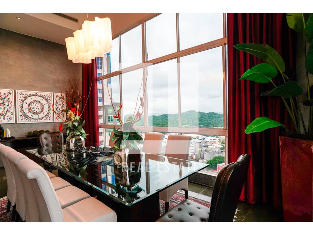 Elegant dining area with floor-to-ceiling windows and skyline views PH Portanova Penthouse