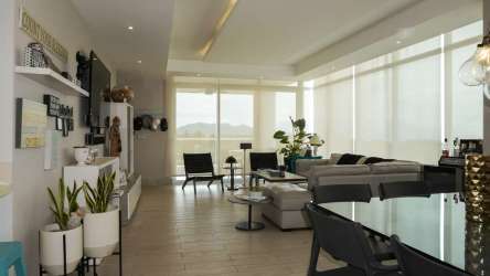 Modern beachfront kitchen with quartz countertops, breakfast bar, stainless appliances