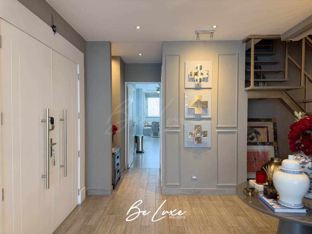 Modern entryway with double doors and staircase in Pearl Tower duplex apartment Costa del Este Panama