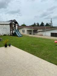Contemporary living dining area with tiled floors, large windows in Colinas del Sol house Arraiján